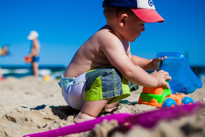 Young child playing on the beach