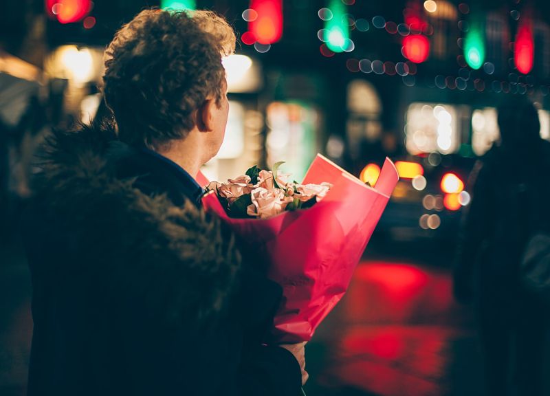 Man holding a bunch of flowers