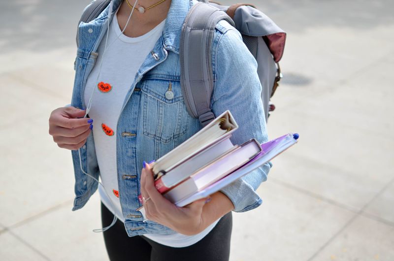 University student carrying books