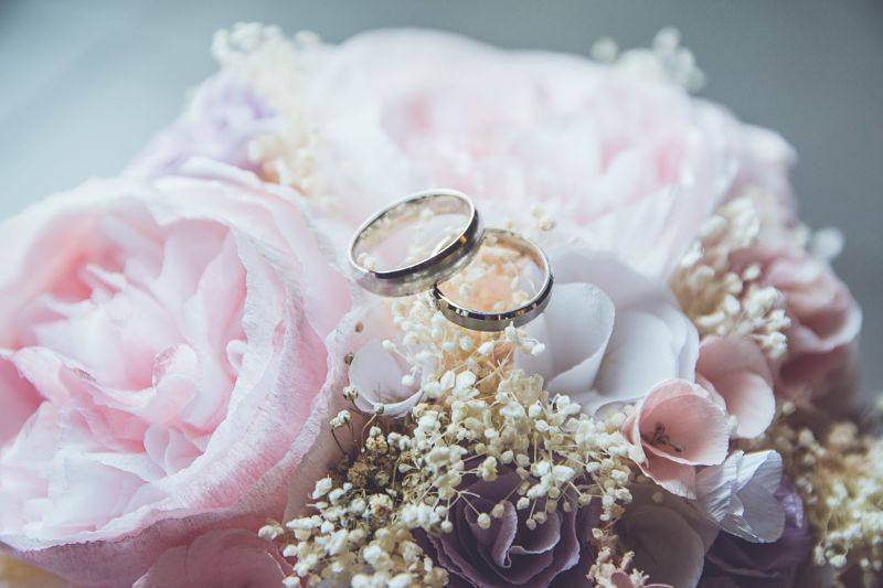 Wedding rings on top of flower bouqet