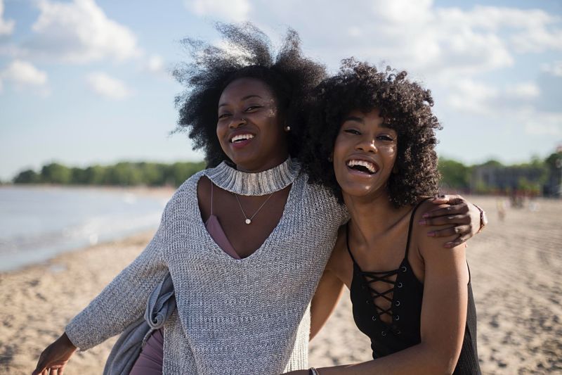 Sisters hugging on beach