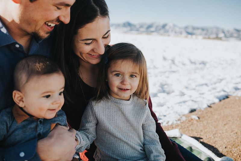 Family smiling in the snow