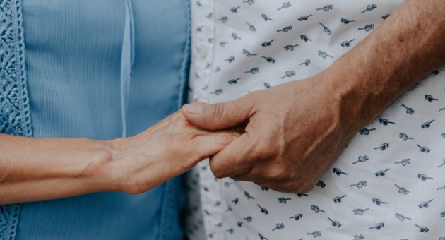 over 50s couple holding hands supported by over 50s insurance