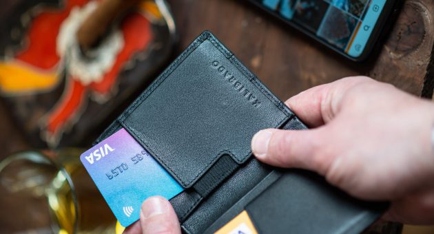 person getting credit card from wallet showing COVD-19 impact on spending