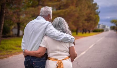 over 50s couple with insurance plans happy together spending their money