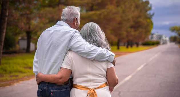 over 50s couple with insurance plans happy together spending their money