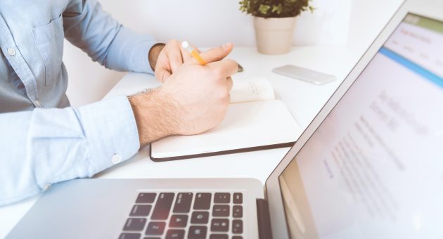 man researching income protection awareness on his macbook