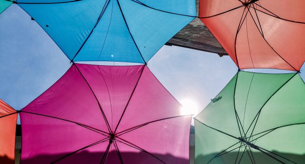 multicoloured umbrellas under sun showing protection payouts by shepherds friendly
