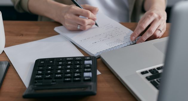 Woman using laptop and calculation to learn how to save more money