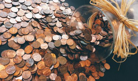 Pot of copper coins saved up highlighting challenges to try if you struggle to save