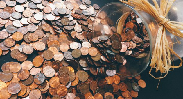 Pot of copper coins saved up highlighting challenges to try if you struggle to save