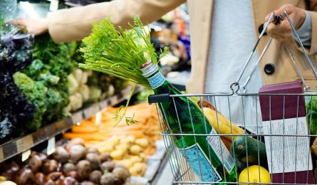 Woman shopping for groceries as cost of living rises