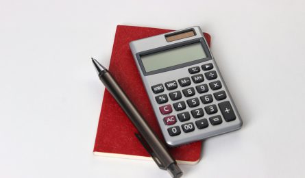Calculator notepad and pen to calculate personal finances