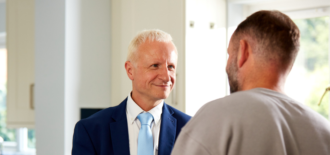 Two men smiling at one another from shepherds friendly advert
